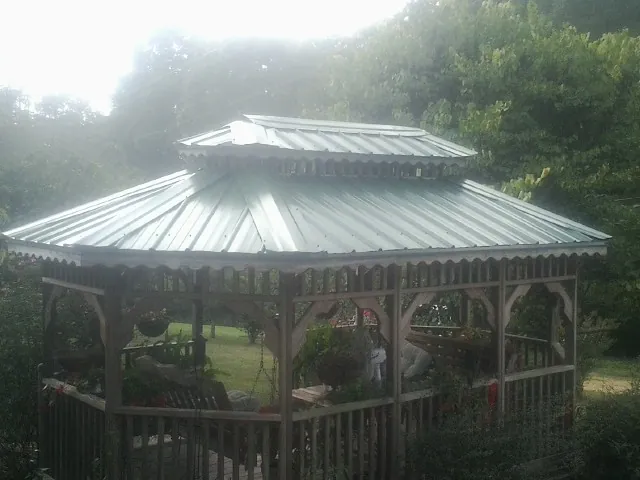 Two tier green metal roof on a garden gazebo in Santa Clara